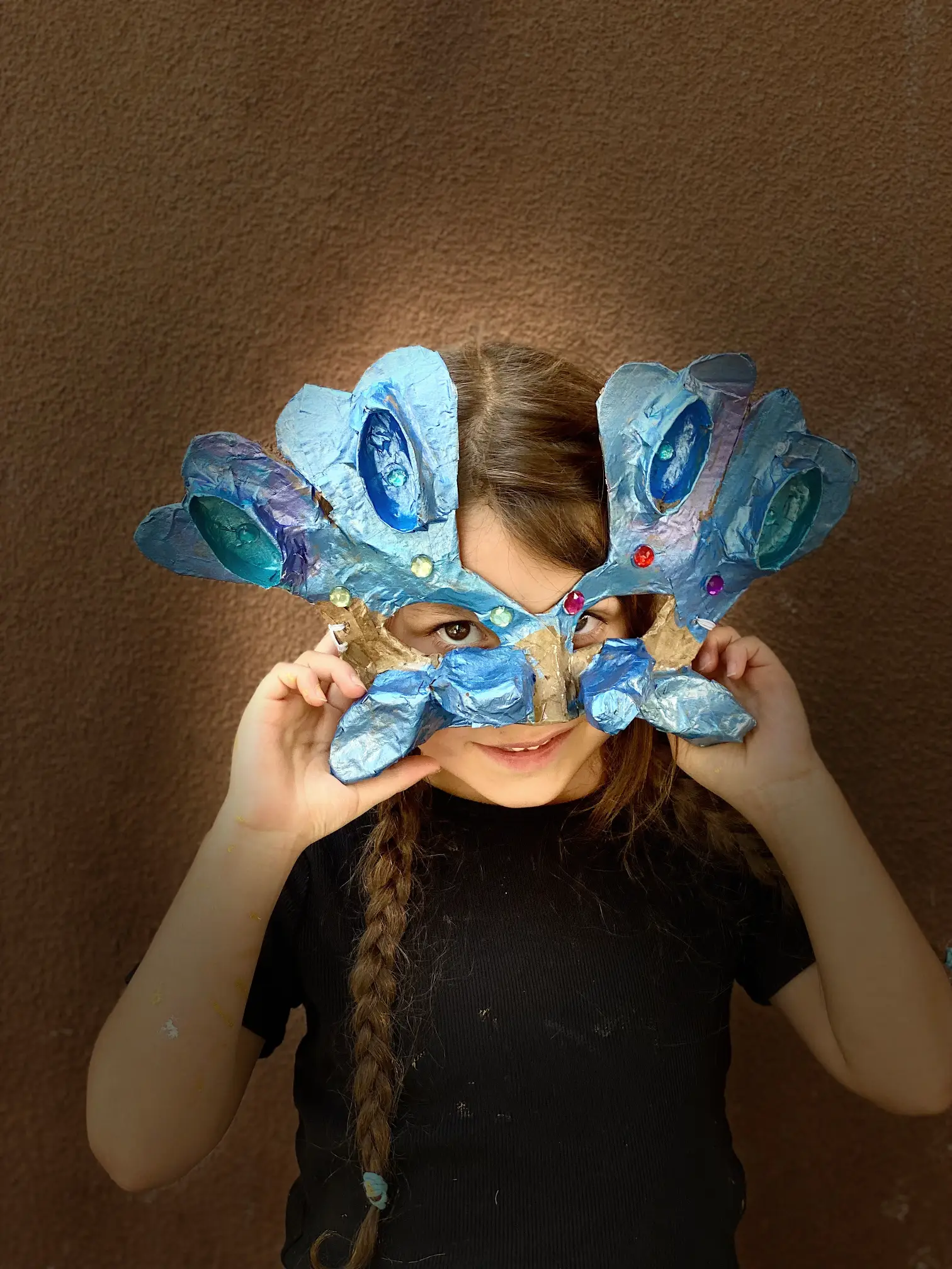 young student shows off colorful mask