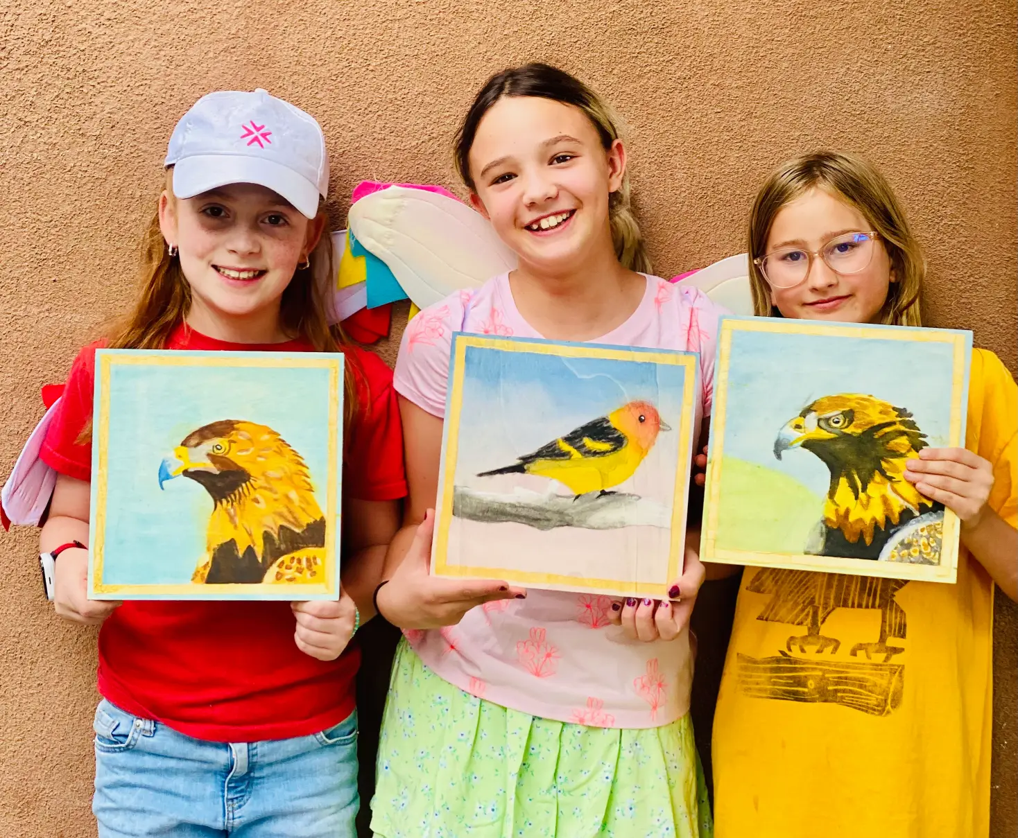 three students show off their artwork