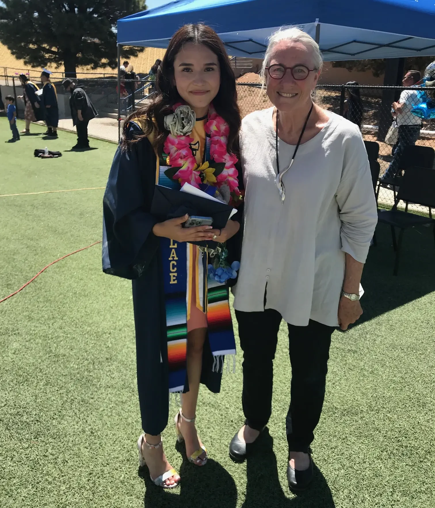 Tanya Medrano, a Santa Fe High School graduate, stands with Dr. Julanna Gilbert during her commencement ceremony. Dr. Gilbert and Medrano collaborated on a computer-based project exploring the creation of art through reiterative mathematics.
