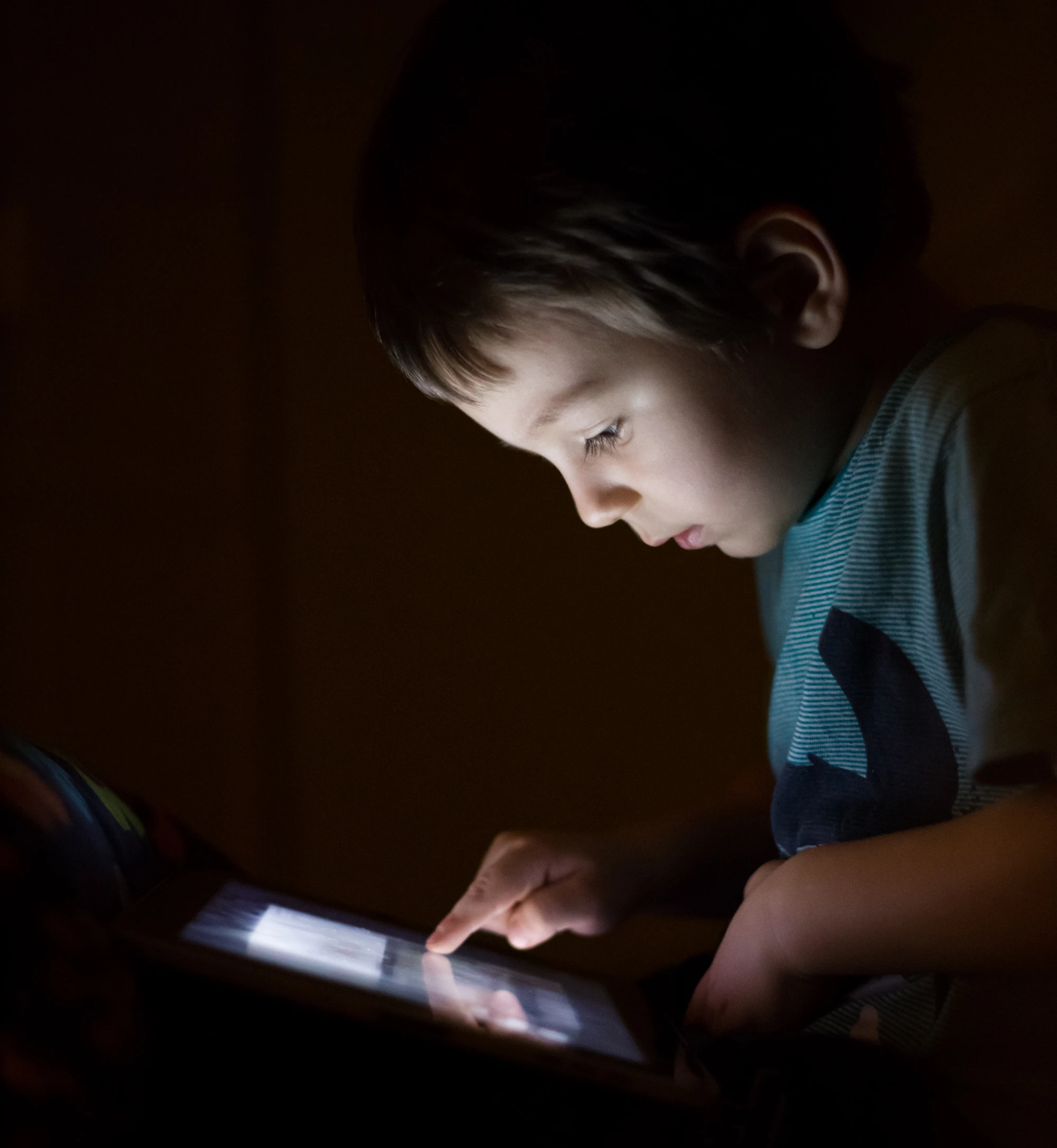 Boy on tablet in the evening