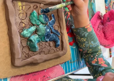 student painting sculpture